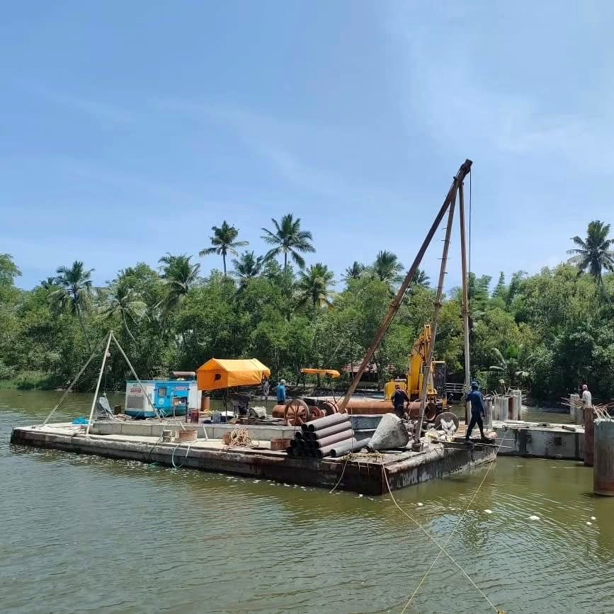Work barge with equipment at the Murukkumpuzha boat terminal